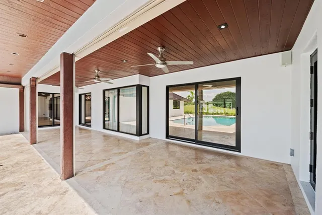 a backyard of a house with a yard and outdoor seating