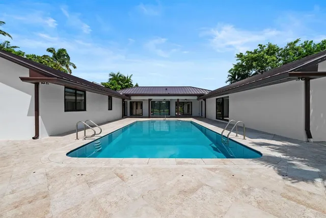 a view of a house with a big yard and potted plants