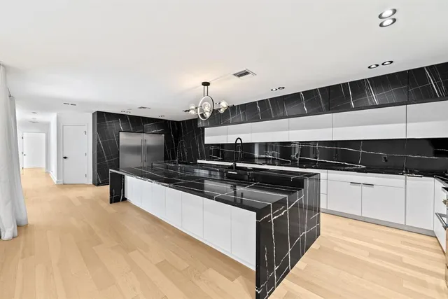 a kitchen with stainless steel appliances a stove and a sink
