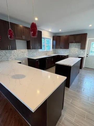 a kitchen with stainless steel appliances a sink dishwasher a stove and a refrigerator