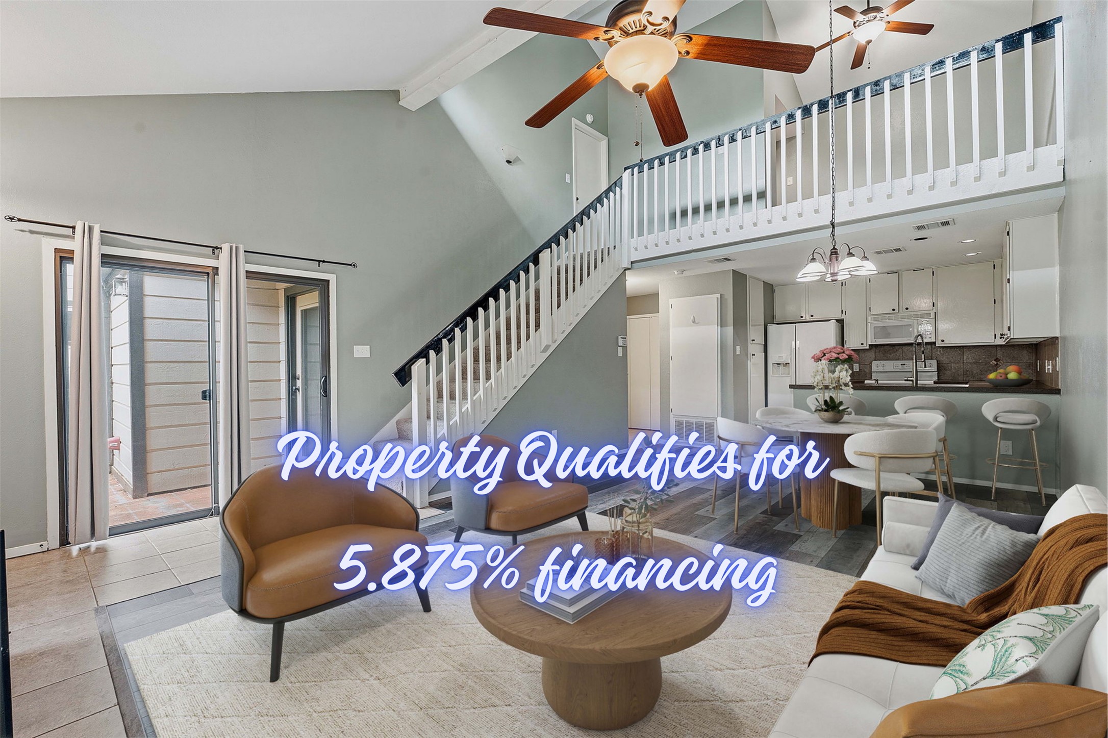 Vaulted ceilings with exposed beams, wood-finish flooring, two ceiling fans with integrated lighting, and a second-story interior balcony