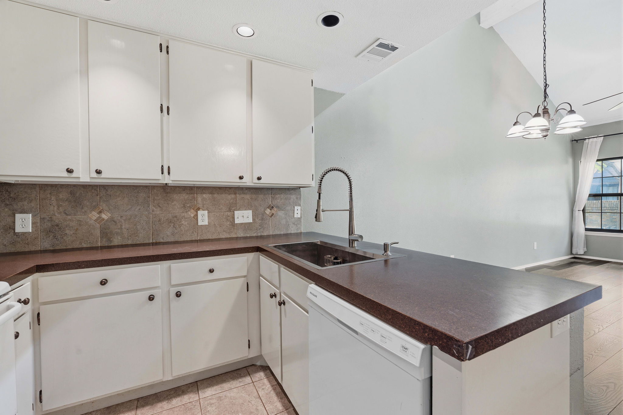 1748 Ohlen Road, Unit 24 Austin, TX 78757 - Photo 12 of 30 a kitchen with granite countertop a sink cabinets and stainless steel appliances