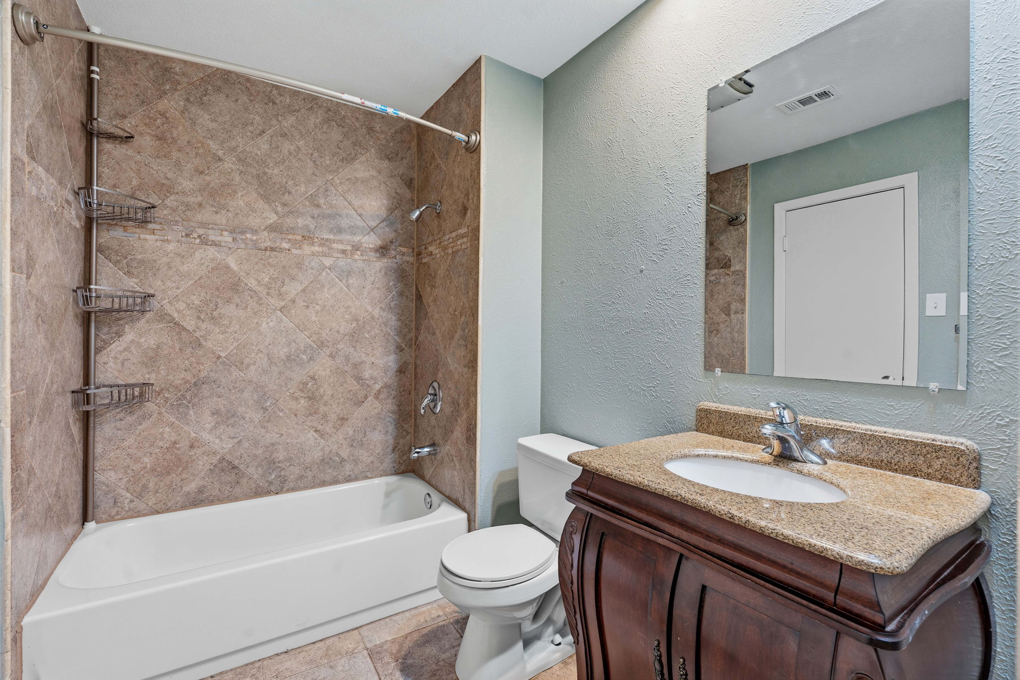 1748 Ohlen Road, Unit 24 Austin, TX 78757 - Photo 18 of 30 a bathroom with a granite countertop sink toilet and shower