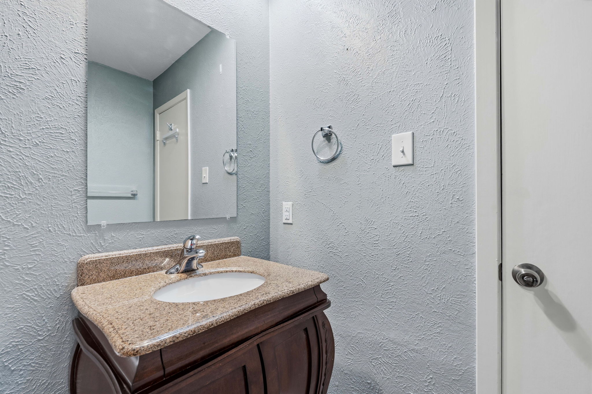 1748 Ohlen Road, Unit 24 Austin, TX 78757 - Photo 19 of 30 a bathroom with a granite countertop sink and a mirror