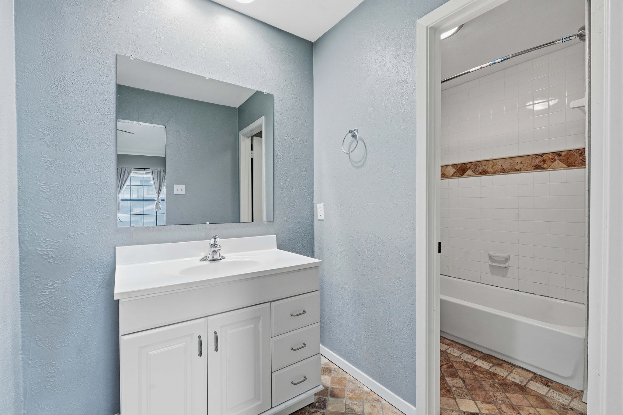 1748 Ohlen Road, Unit 24 Austin, TX 78757 - Photo 22 of 30 a bathroom with a shower sink vanity and mirror