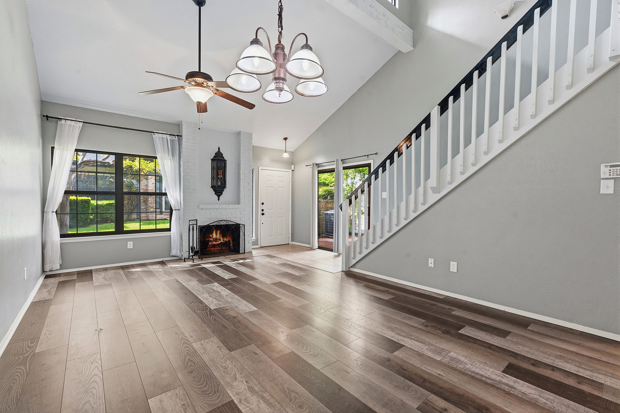 1748 Ohlen Road, Unit 24 Austin, TX 78757 - Photo 6 of 30 a view of an empty room with wooden floor fireplace and a window