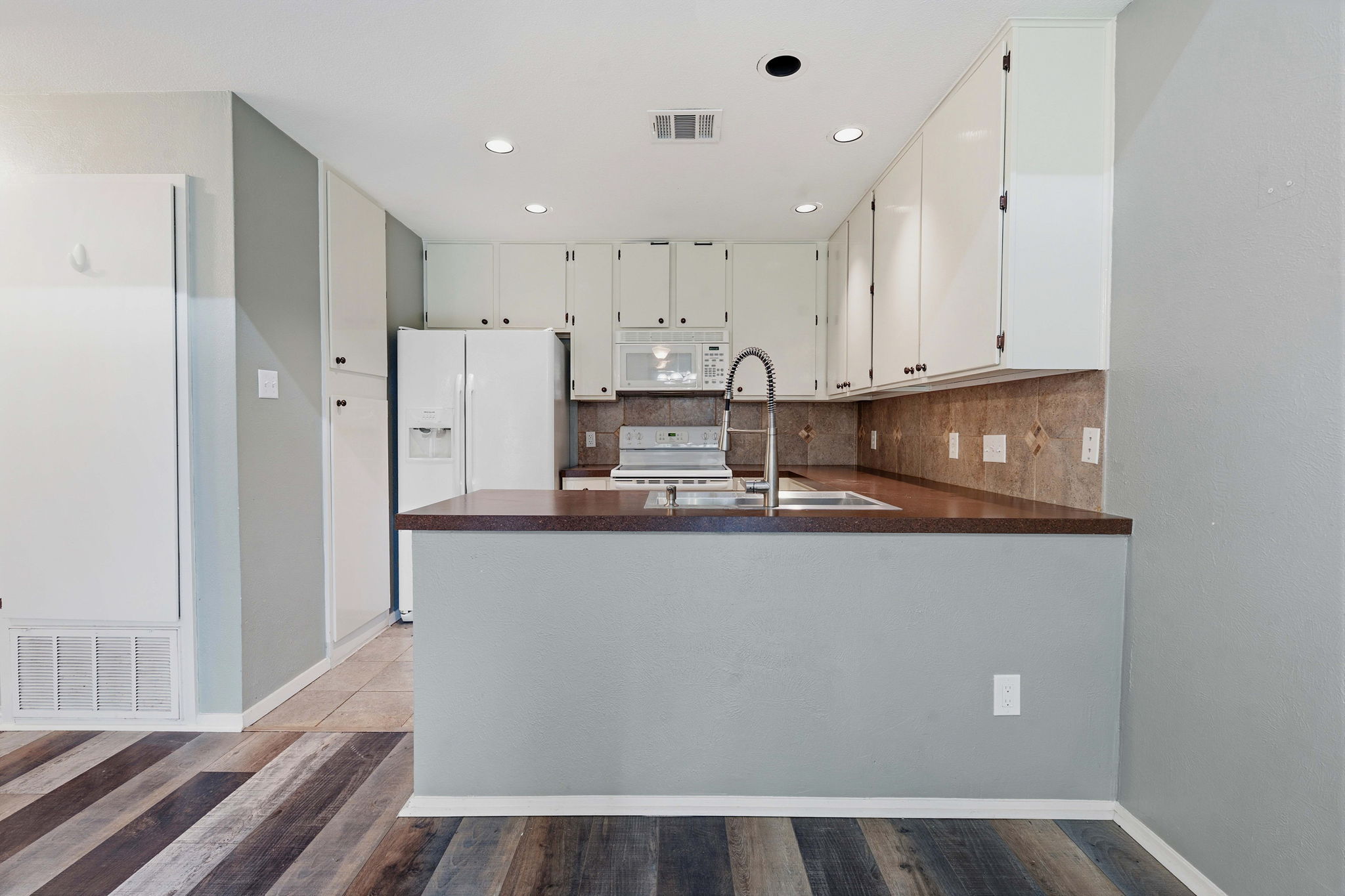 1748 Ohlen Road, Unit 24 Austin, TX 78757 - Photo 9 of 30 a view of kitchen with stainless steel appliances granite countertop refrigerator sink and cabinets