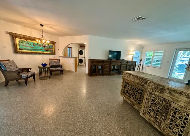 a living room with a table and a large window