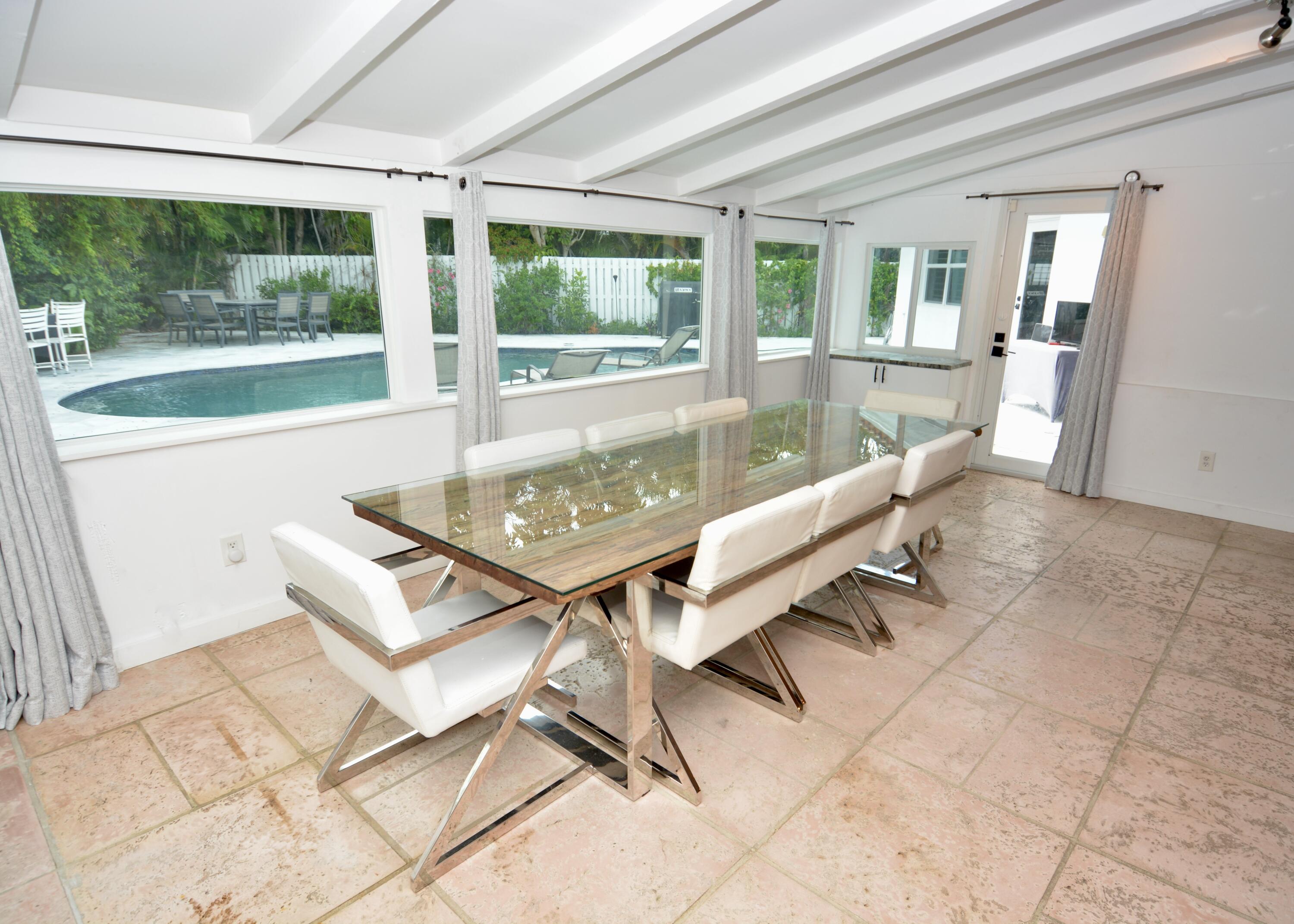 212 Kings Lynn Delray Beach, FL 33444 - Photo 14 of 53 a living room with a table and a large window