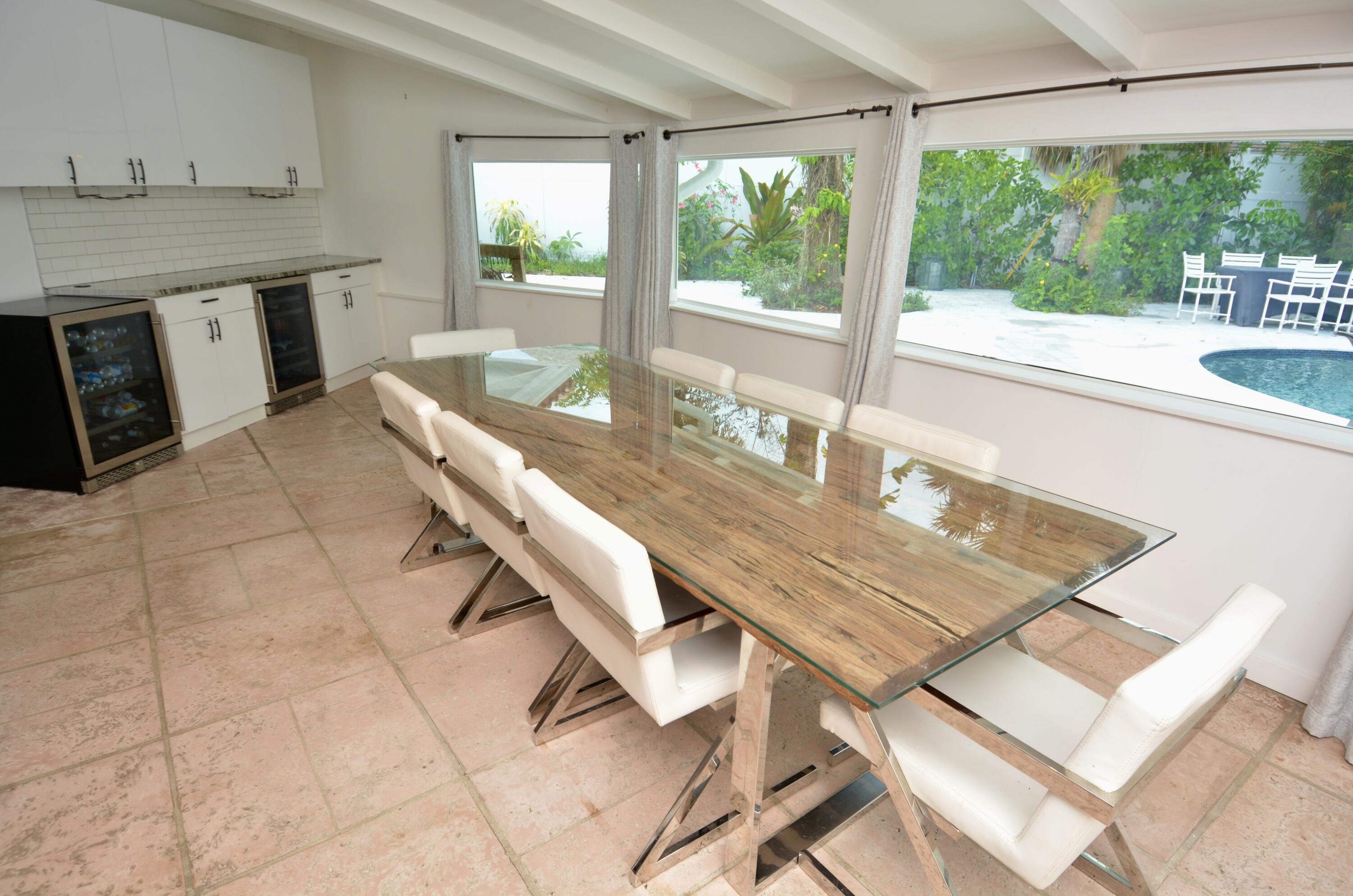 212 Kings Lynn Delray Beach, FL 33444 - Photo 15 of 53 a dining room with a table and chairs