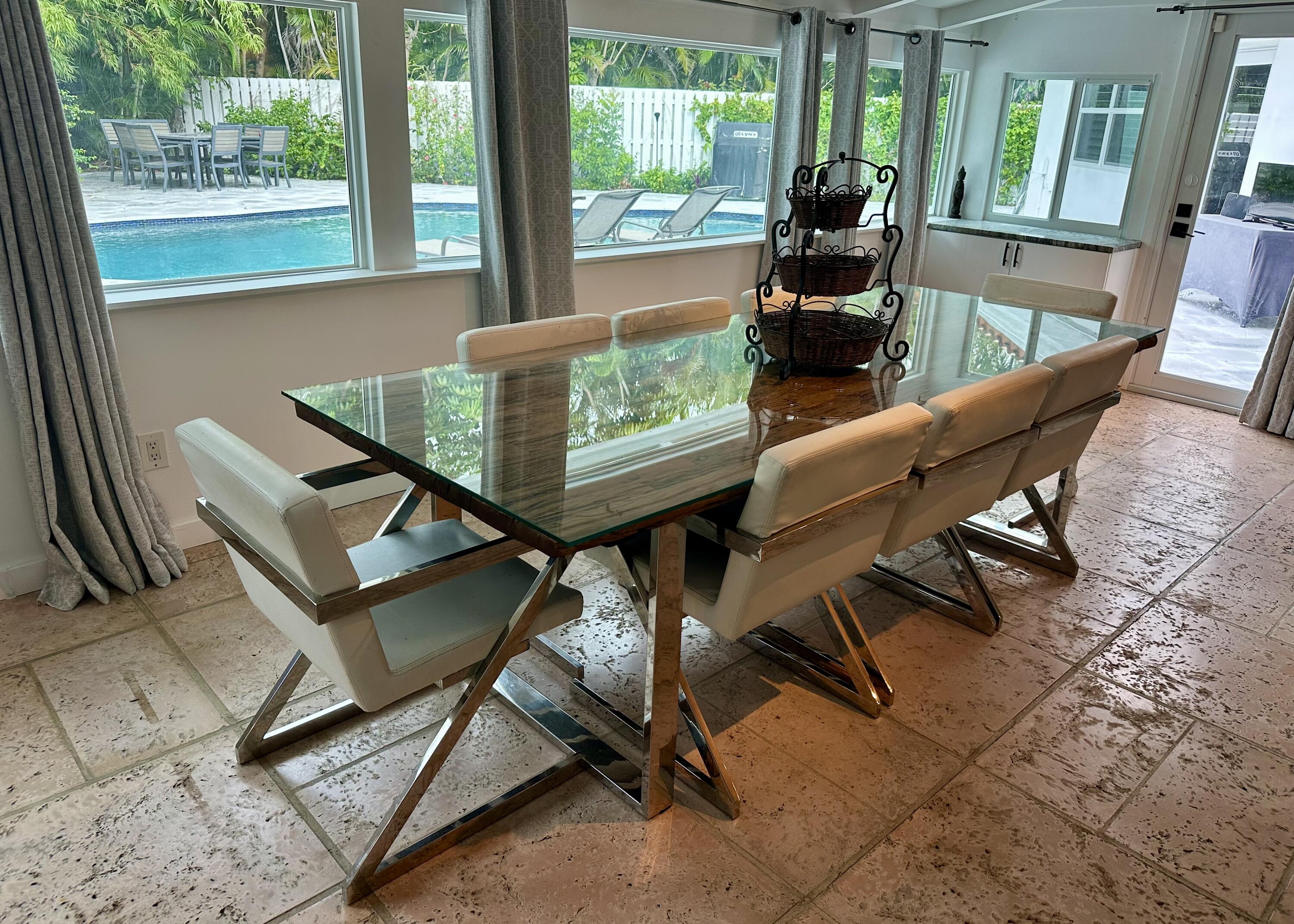212 Kings Lynn Delray Beach, FL 33444 - Photo 17 of 53 a dining room with furniture and floor to ceiling windows