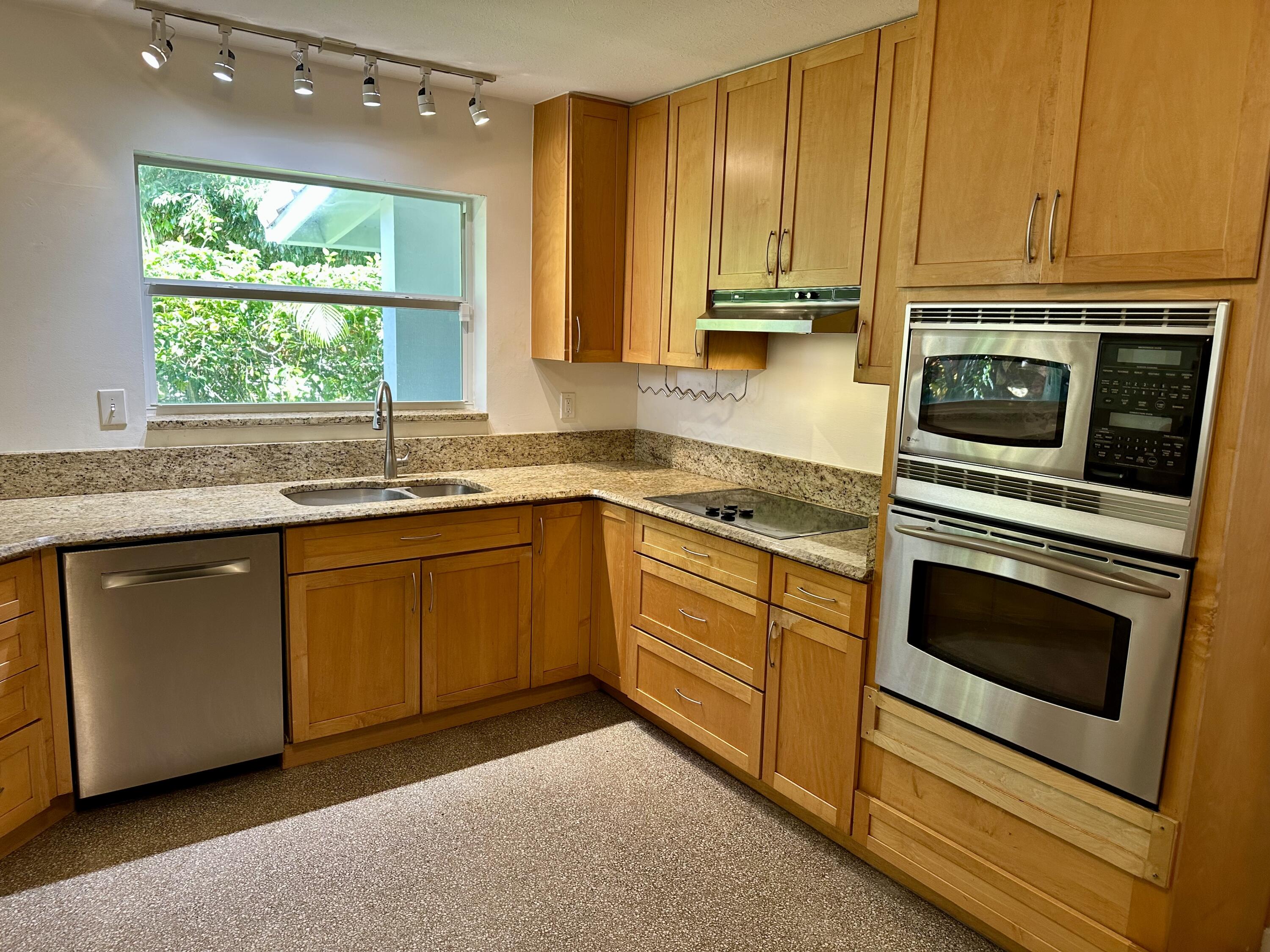 212 Kings Lynn Delray Beach, FL 33444 - Photo 20 of 53 a kitchen with appliances cabinets and a sink