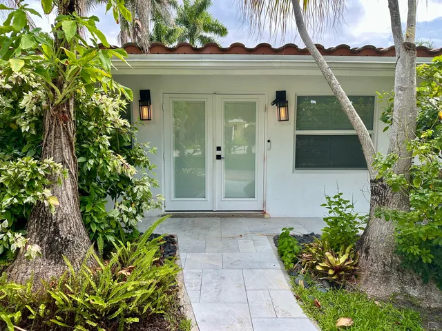 a front view of a house with a garden