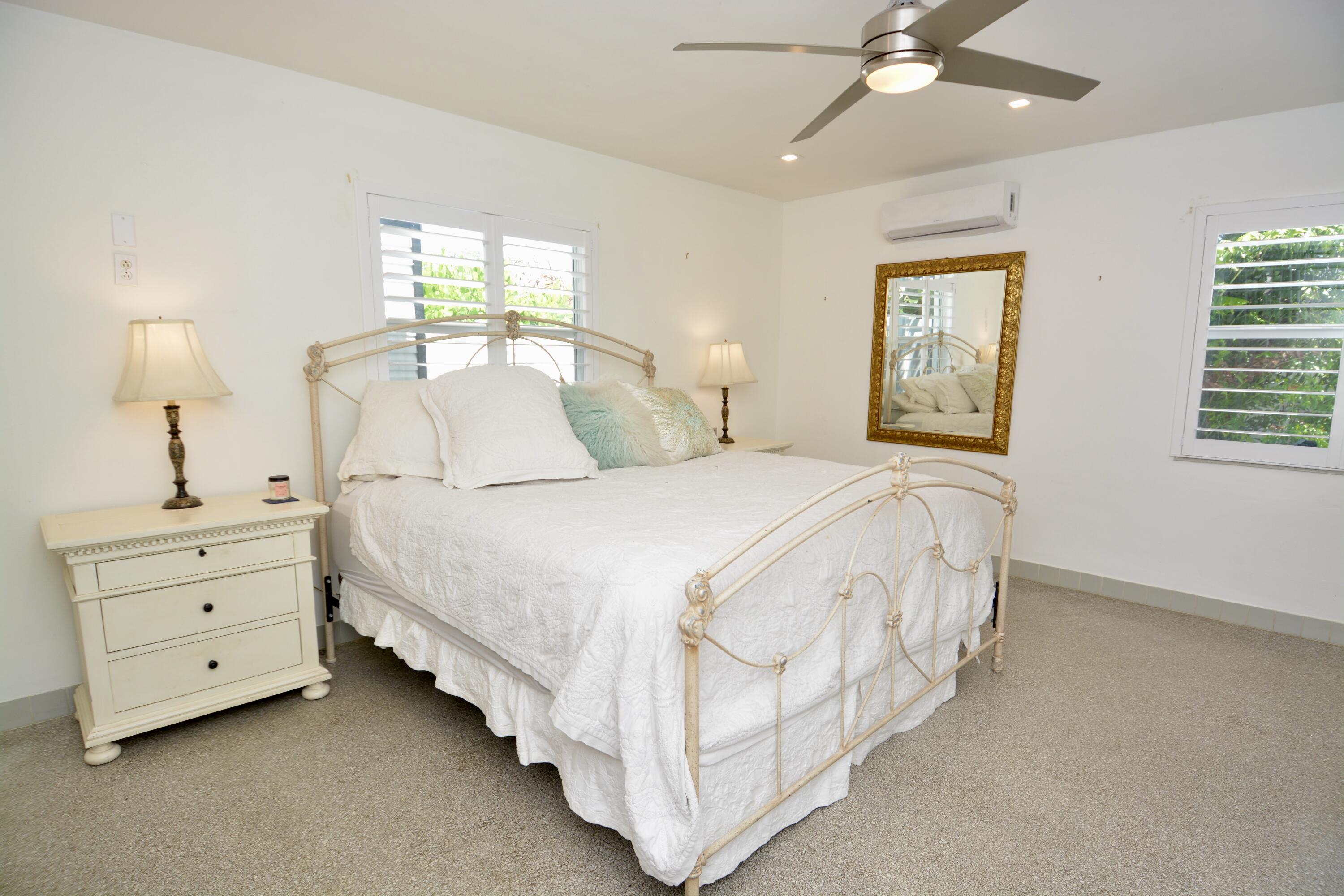 212 Kings Lynn Delray Beach, FL 33444 - Photo 24 of 53 a spacious bedroom with a bed and a window