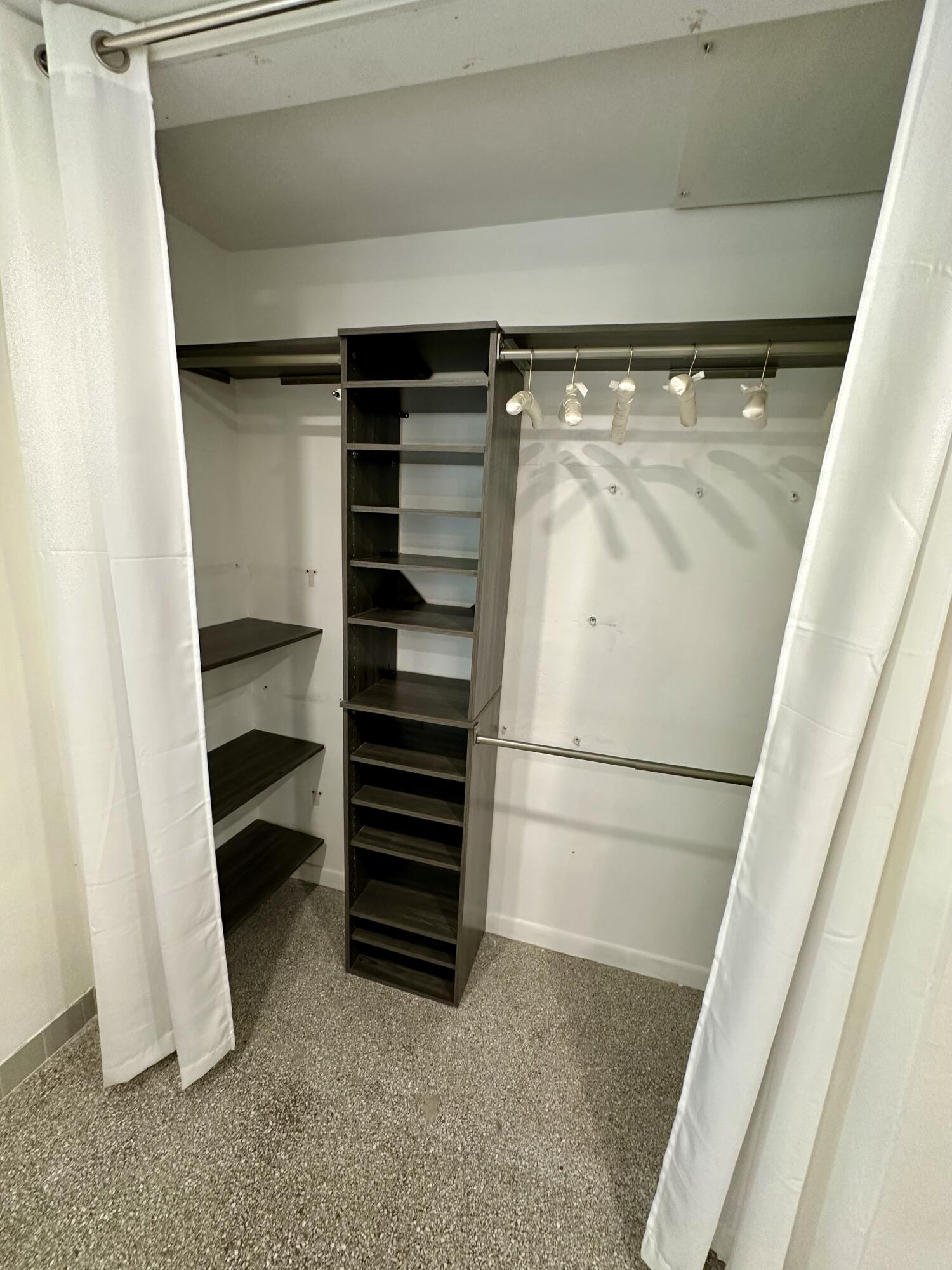 212 Kings Lynn Delray Beach, FL 33444 - Photo 32 of 53 a view of walk in closet with empty racks