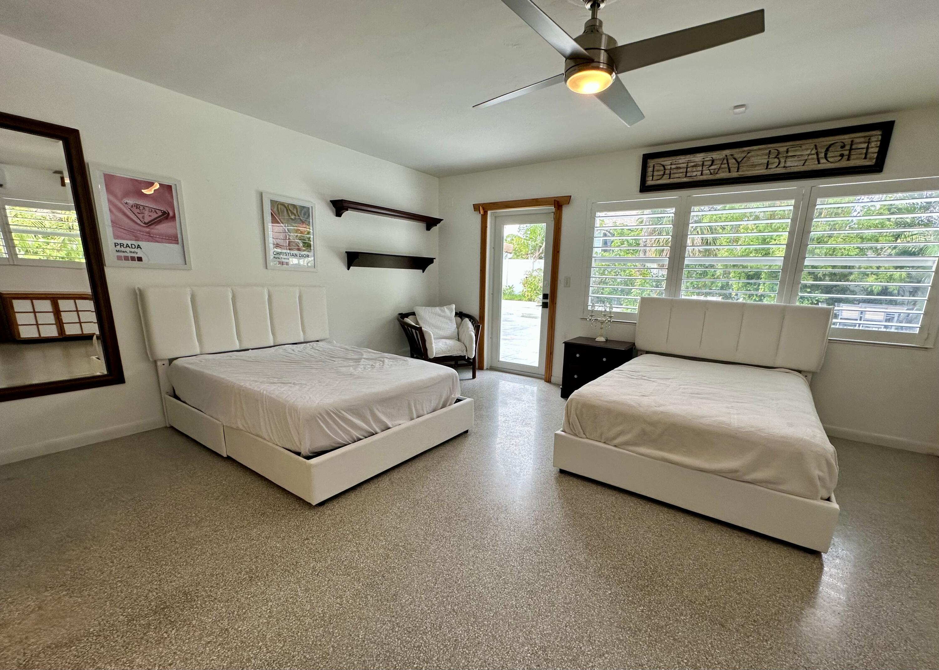 212 Kings Lynn Delray Beach, FL 33444 - Photo 36 of 53 a bedroom with a bed hardwood floor and window