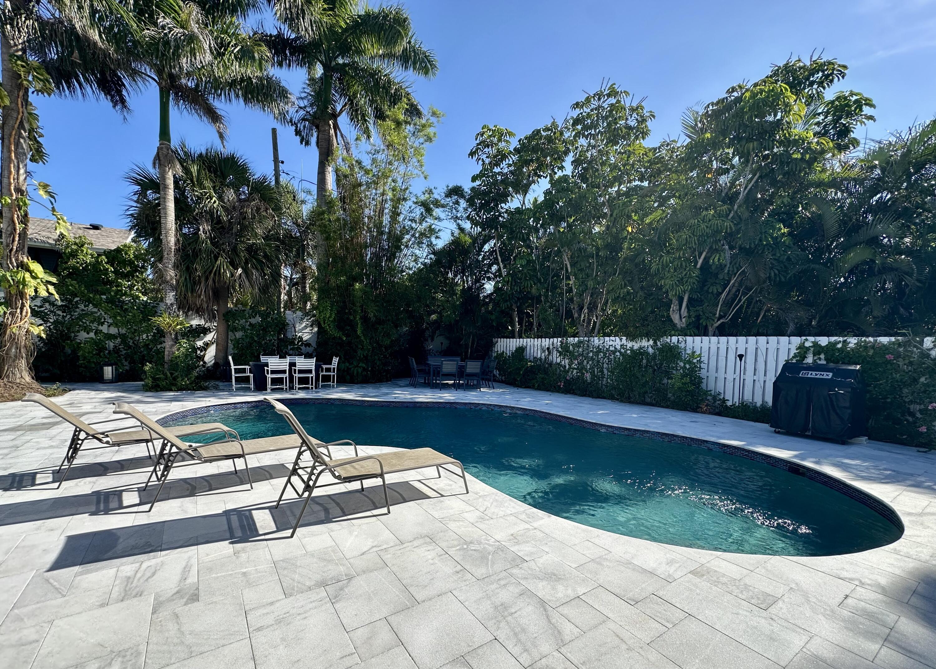 212 Kings Lynn Delray Beach, FL 33444 - Photo 41 of 53 a view of a swimming pool with a patio