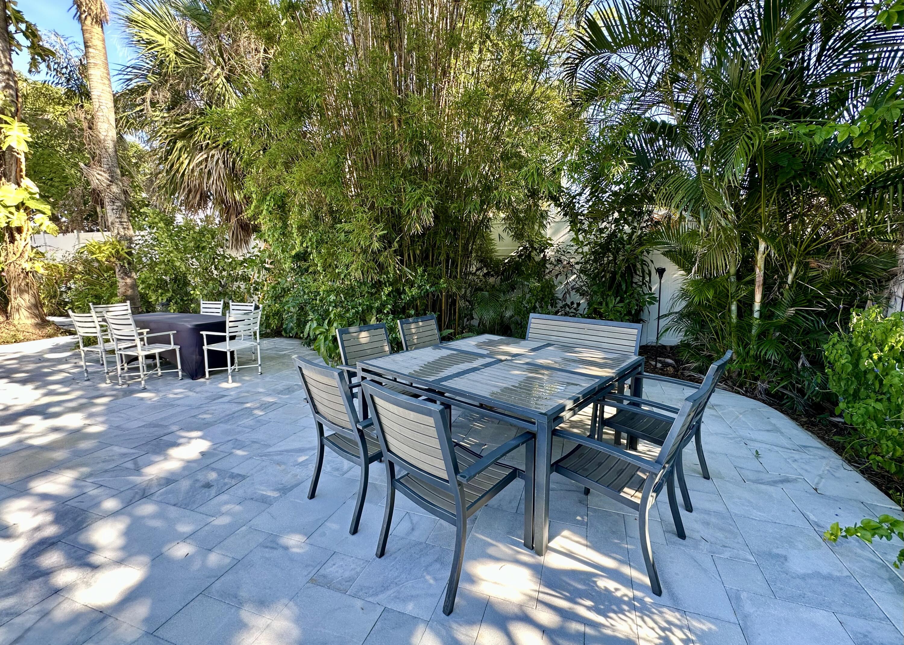 212 Kings Lynn Delray Beach, FL 33444 - Photo 44 of 53 a view of a backyard with table and chairs
