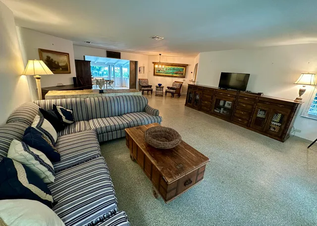 a living room with furniture and large windows