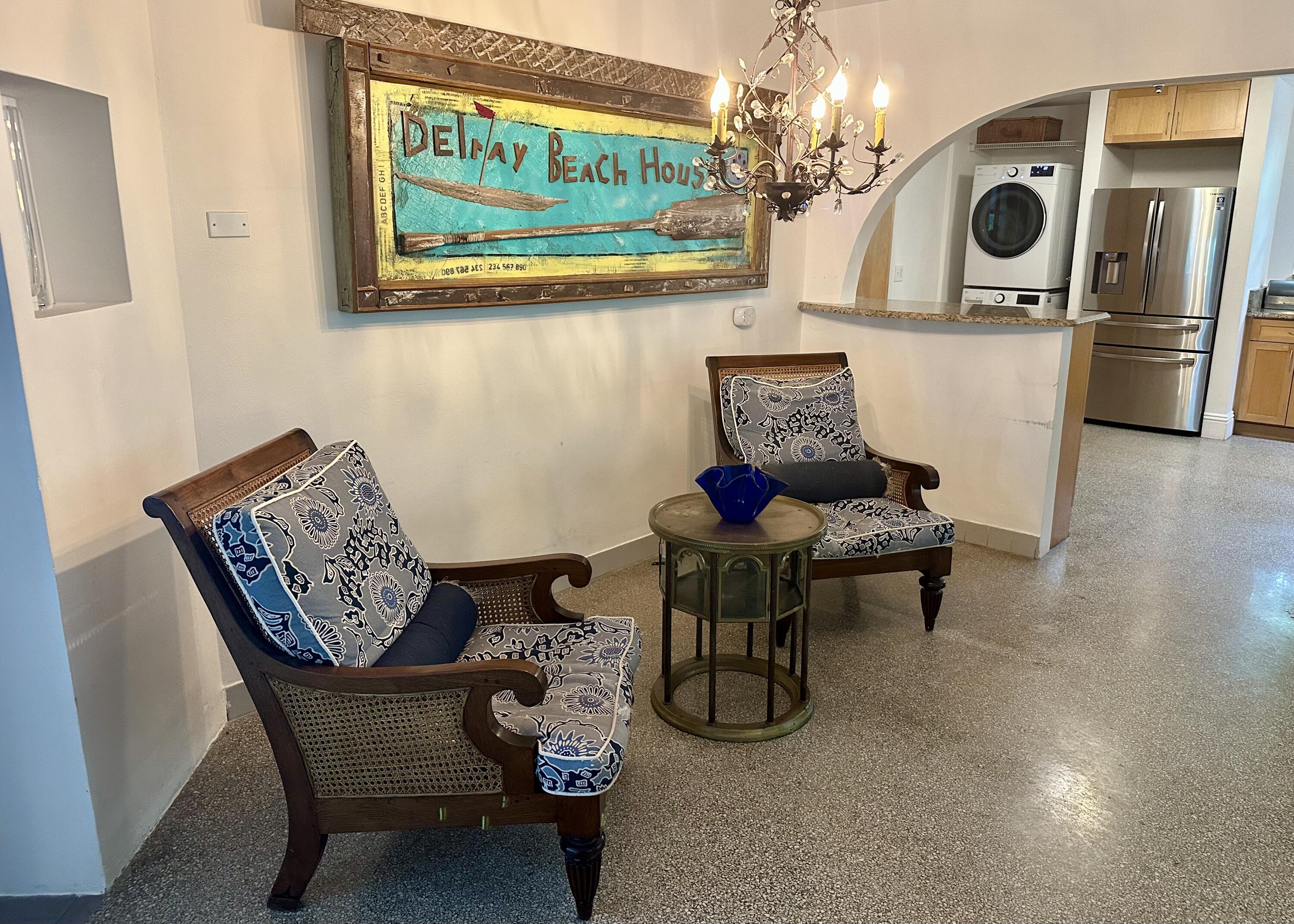 212 Kings Lynn Delray Beach, FL 33444 - Photo 9 of 53 a view of a dining room with furniture a chandelier and wooden floor