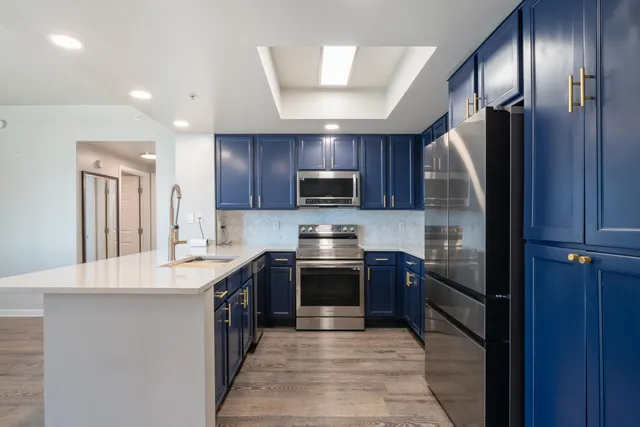 a kitchen with stainless steel appliances granite countertop granite top a refrigerator and a sink