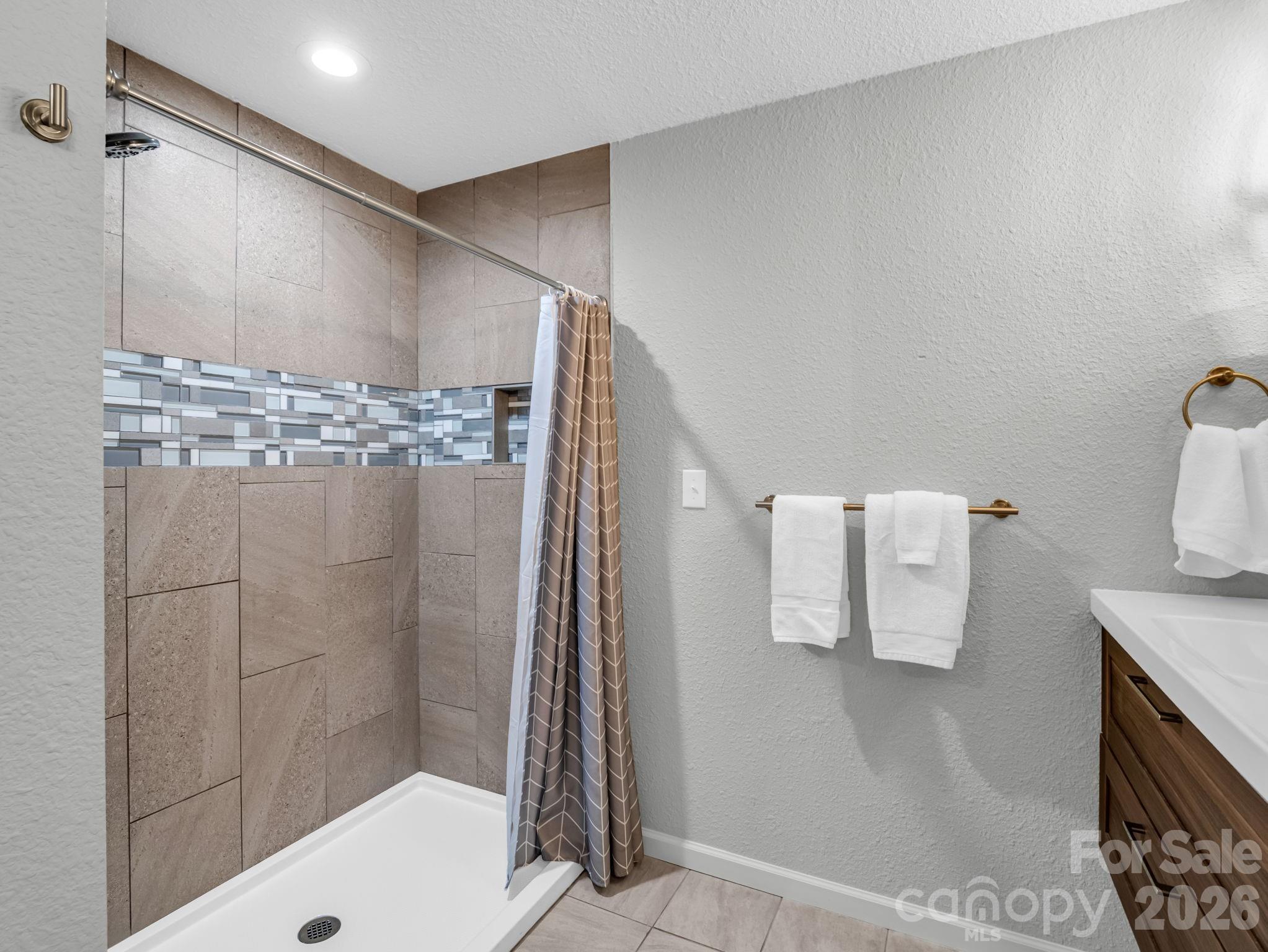 656 Cashiers Valley Road Brevard, NC 28712 - Photo 16 of 37 a bathroom with a shower and a sink