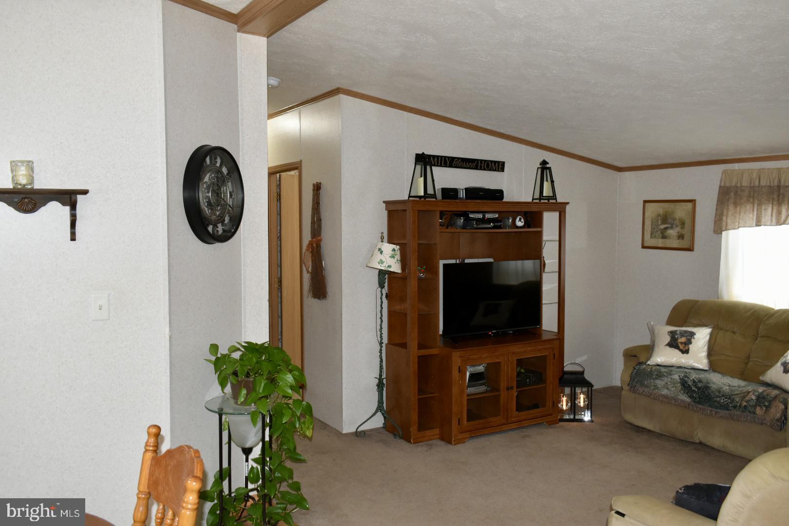 38 Broadwing Drive Hanover, PA 17331 - Photo 23 of 37 a living room with furniture a flat screen tv and a wall clock