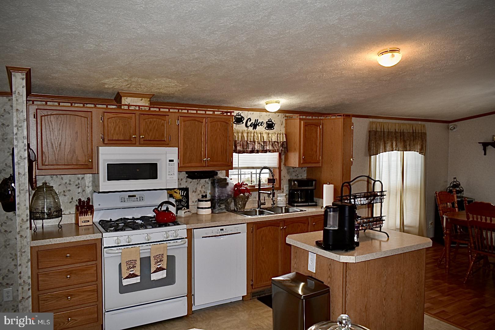 38 Broadwing Drive Hanover, PA 17331 - Photo 6 of 37 a kitchen with kitchen island a stove a sink and a refrigerator