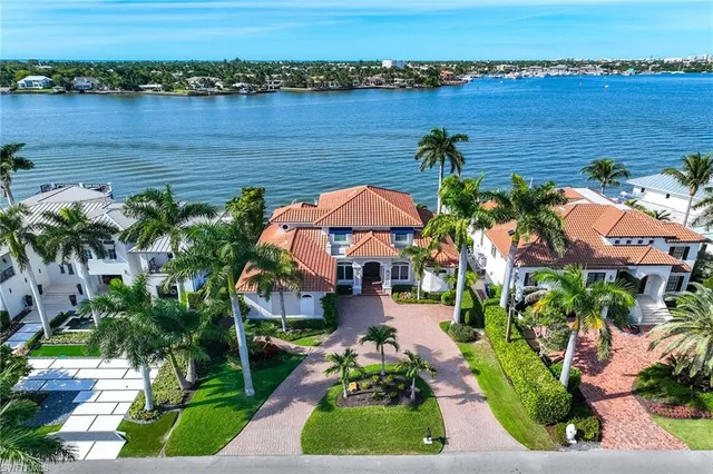 an aerial view of ocean with residential house with outdoor space