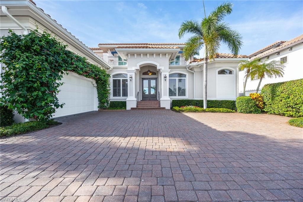 1942 Kingfish Road Naples, FL 34102 - Photo 12 of 50 a front view of a house with garden