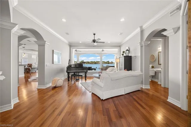 a living room with furniture and a wooden floor