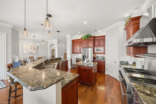 a kitchen with stainless steel appliances granite countertop a stove and a sink