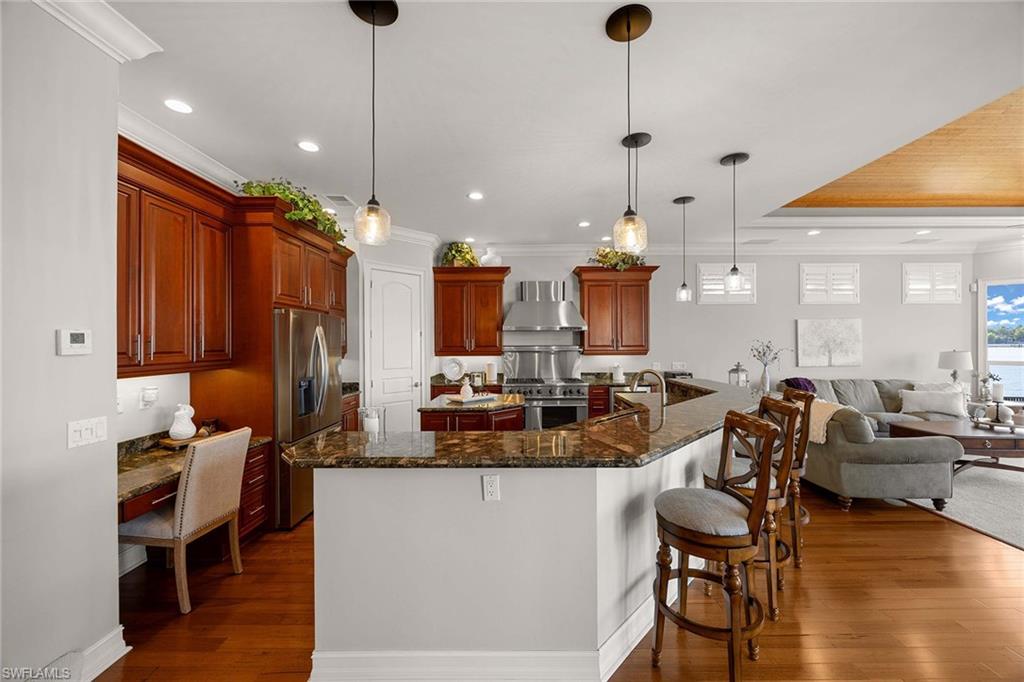 1942 Kingfish Road Naples, FL 34102 - Photo 49 of 50 a large kitchen with a table and chairs