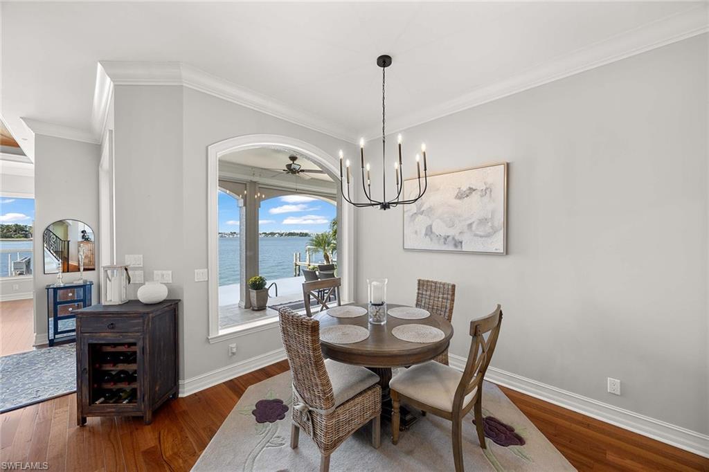 1942 Kingfish Road Naples, FL 34102 - Photo 21 of 50 a view of a dining room with furniture window and wooden floor