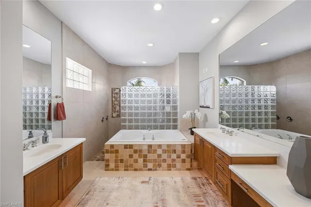 a bedroom with a bed ceiling fan and a window