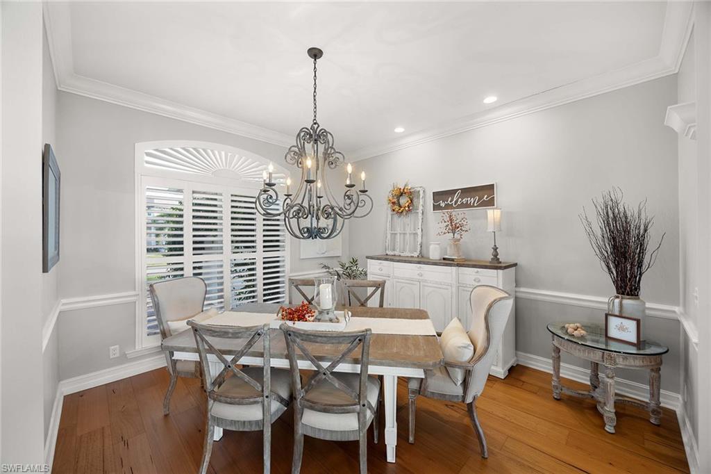 1942 Kingfish Road Naples, FL 34102 - Photo 28 of 50 a view of a dining room with furniture window and wooden floor