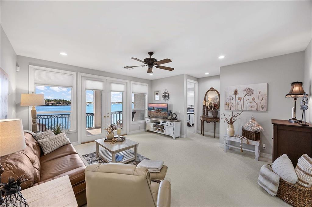 1942 Kingfish Road Naples, FL 34102 - Photo 33 of 50 a living room with furniture a fireplace and a large window