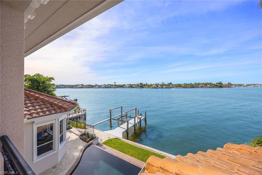 1942 Kingfish Road Naples, FL 34102 - Photo 36 of 50 a view of a terrace with wooden floor and lake view