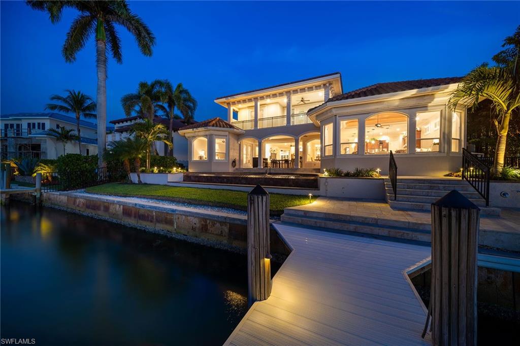 1942 Kingfish Road Naples, FL 34102 - Photo 4 of 50 a living room with furniture a bed and a potted plants