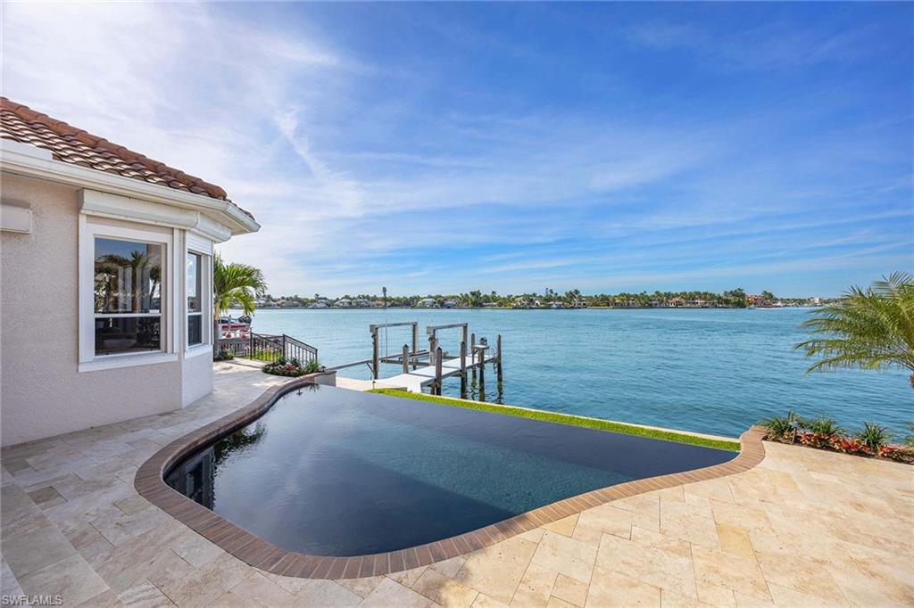 1942 Kingfish Road Naples, FL 34102 - Photo 44 of 50 a view of a swimming pool with an ocean view