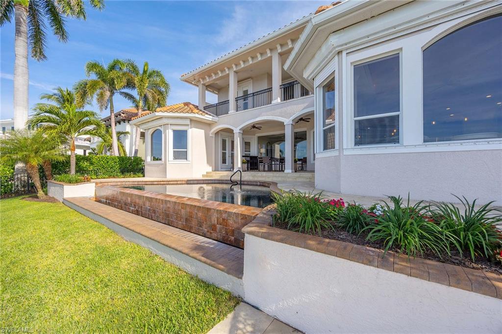 1942 Kingfish Road Naples, FL 34102 - Photo 47 of 50 a front view of a house with a yard