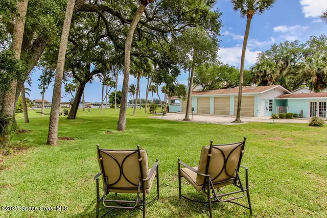 a view of house with a garden and patio
