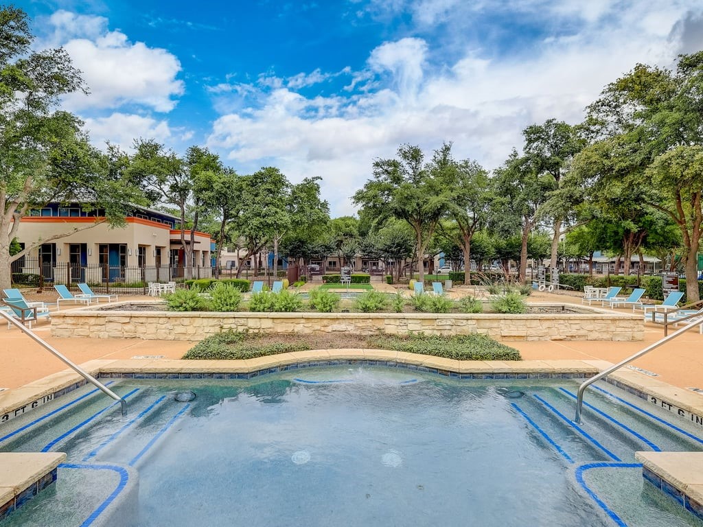 a view of swimming pool and trees in the background