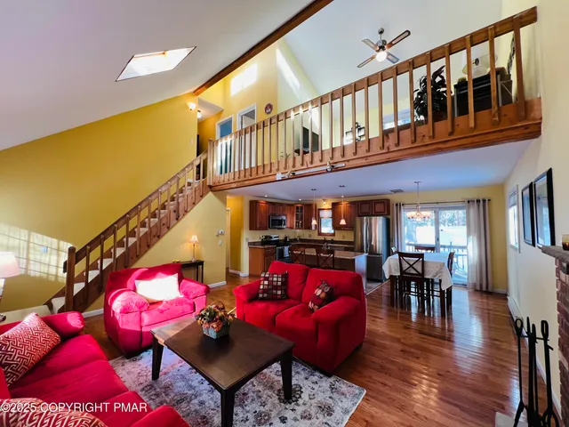 a living room with furniture fireplace and wooden floor