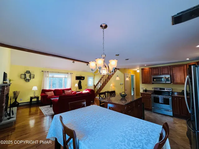 a living room with furniture a dining table and a wooden floor