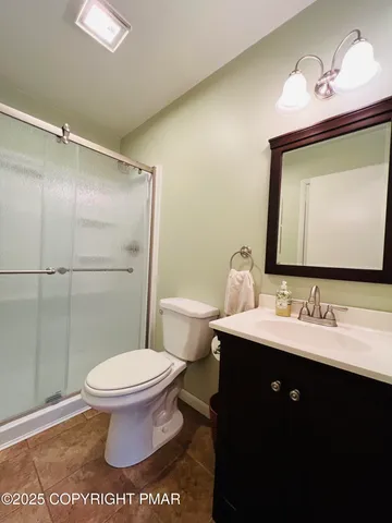 a bathroom with a sink toilet and mirror