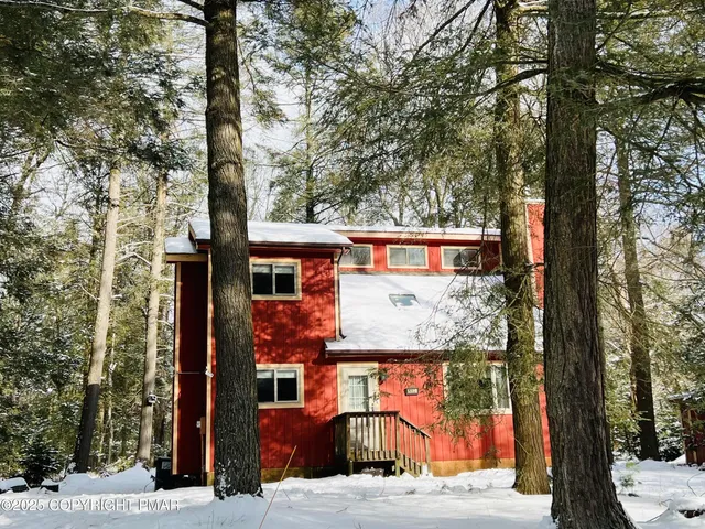 a view of a house with a tree