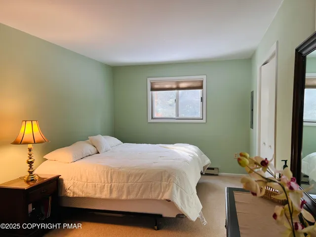 a bedroom with a bed and a lamp