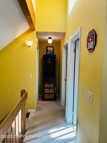 a view of a hallway with wooden shelves
