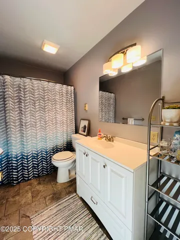 a bathroom with a sink toilet and shower